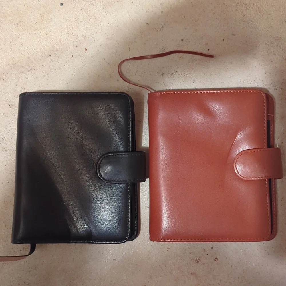 Two midi Budd fine leather pocket diary agenda books with snap closure.