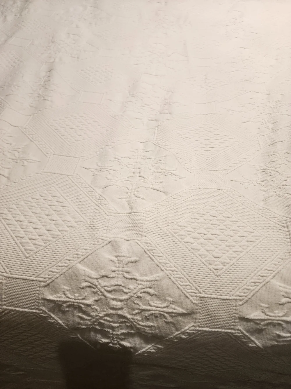White Peacock Alley Oasis coverlet features a textured matelassé design