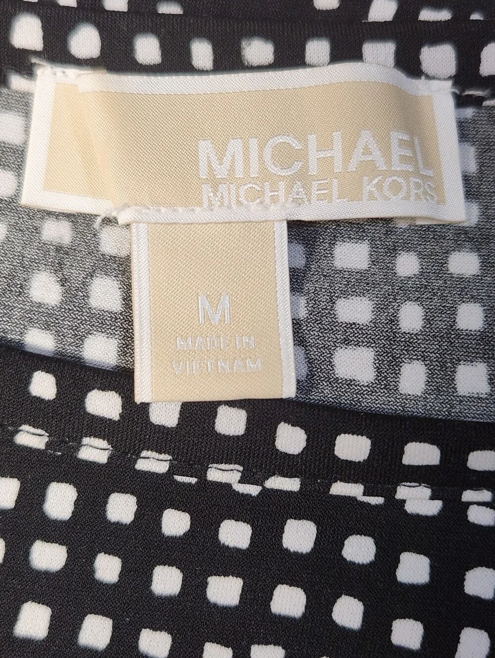 Michael Kors measures laying