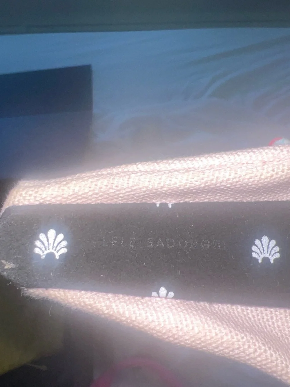 Lele Sadoughi pale pink headband with silver motifs
