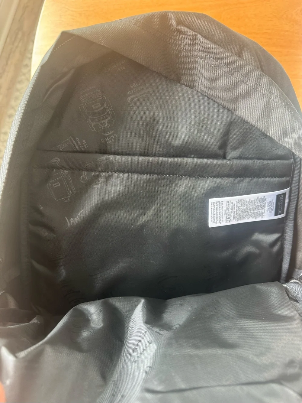 Jansport Black Backpack with Blue Logo Patch