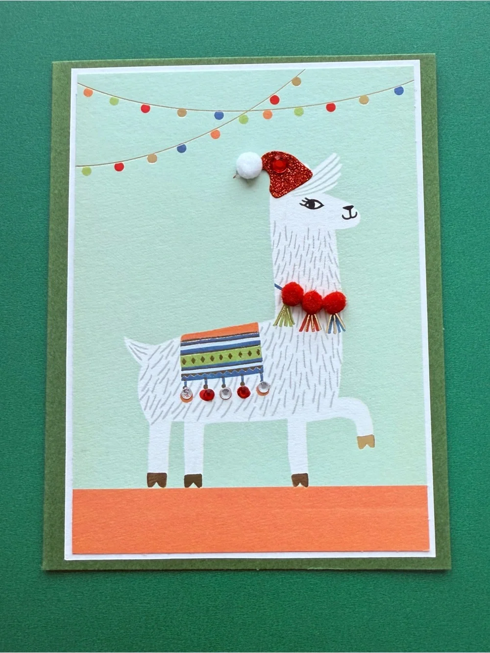 Llama Holiday Card - featuring an adorned “ticas” necklace & “aretes” blanket.