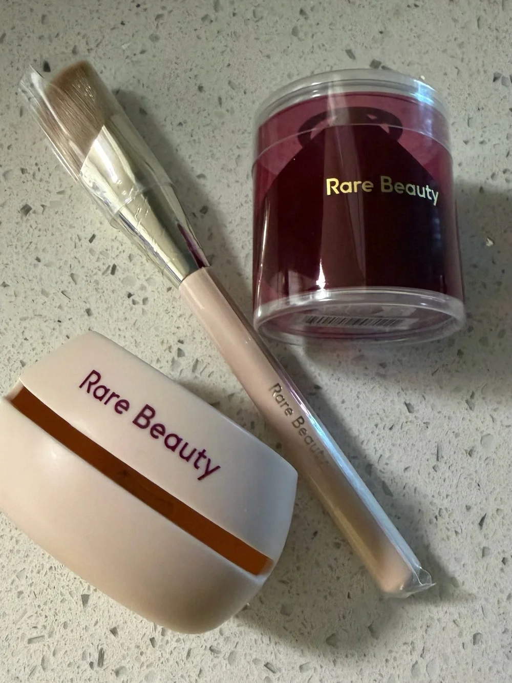 Rare Beauty brush, sponge case and burgundy powder jar