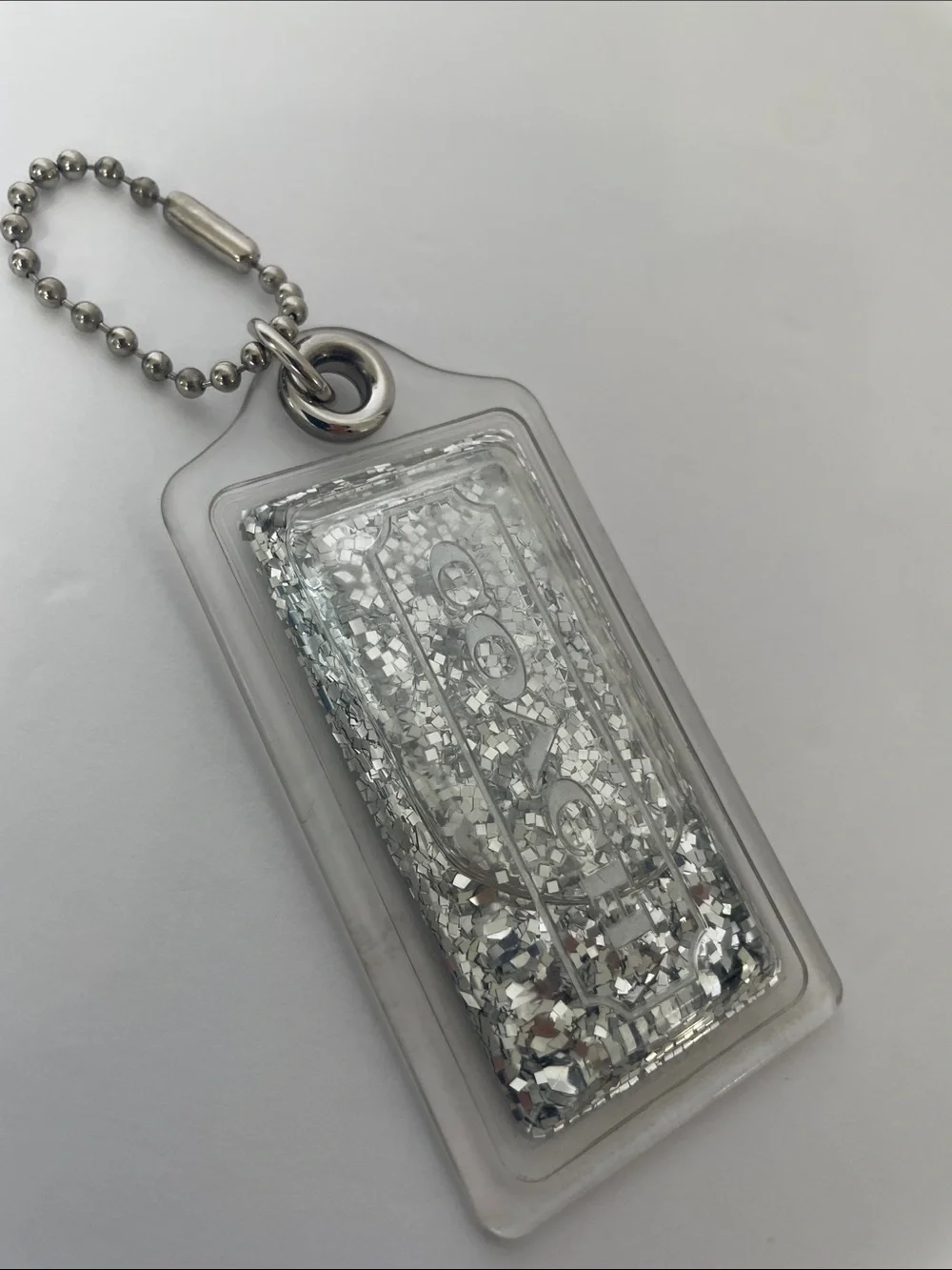 Coach Liquid Glitter Acrylic Hang Tag Clear | Silver