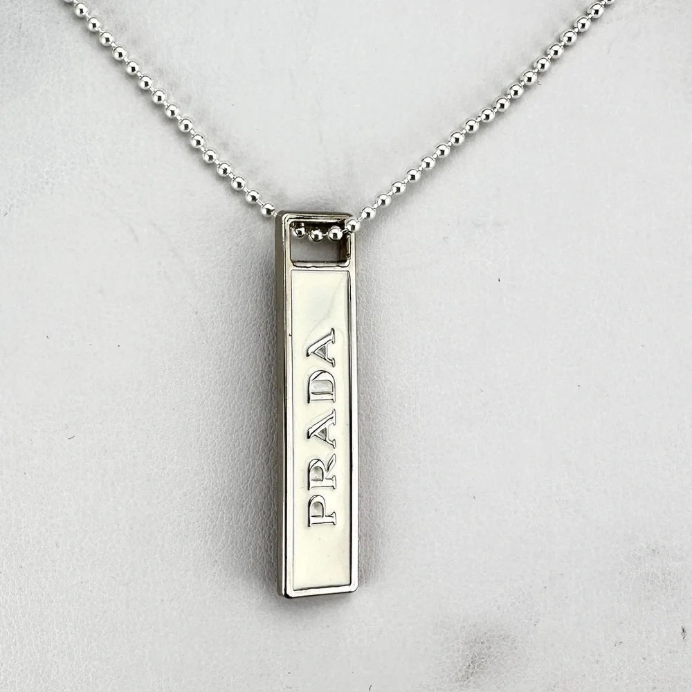 Prada charm w/bonus gift. AUTHENTIC White and silver.