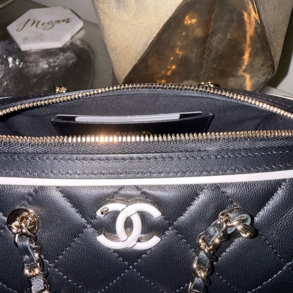 CHANEL Black Quilted Shoulder Bag with White Trim and Silver Hardware