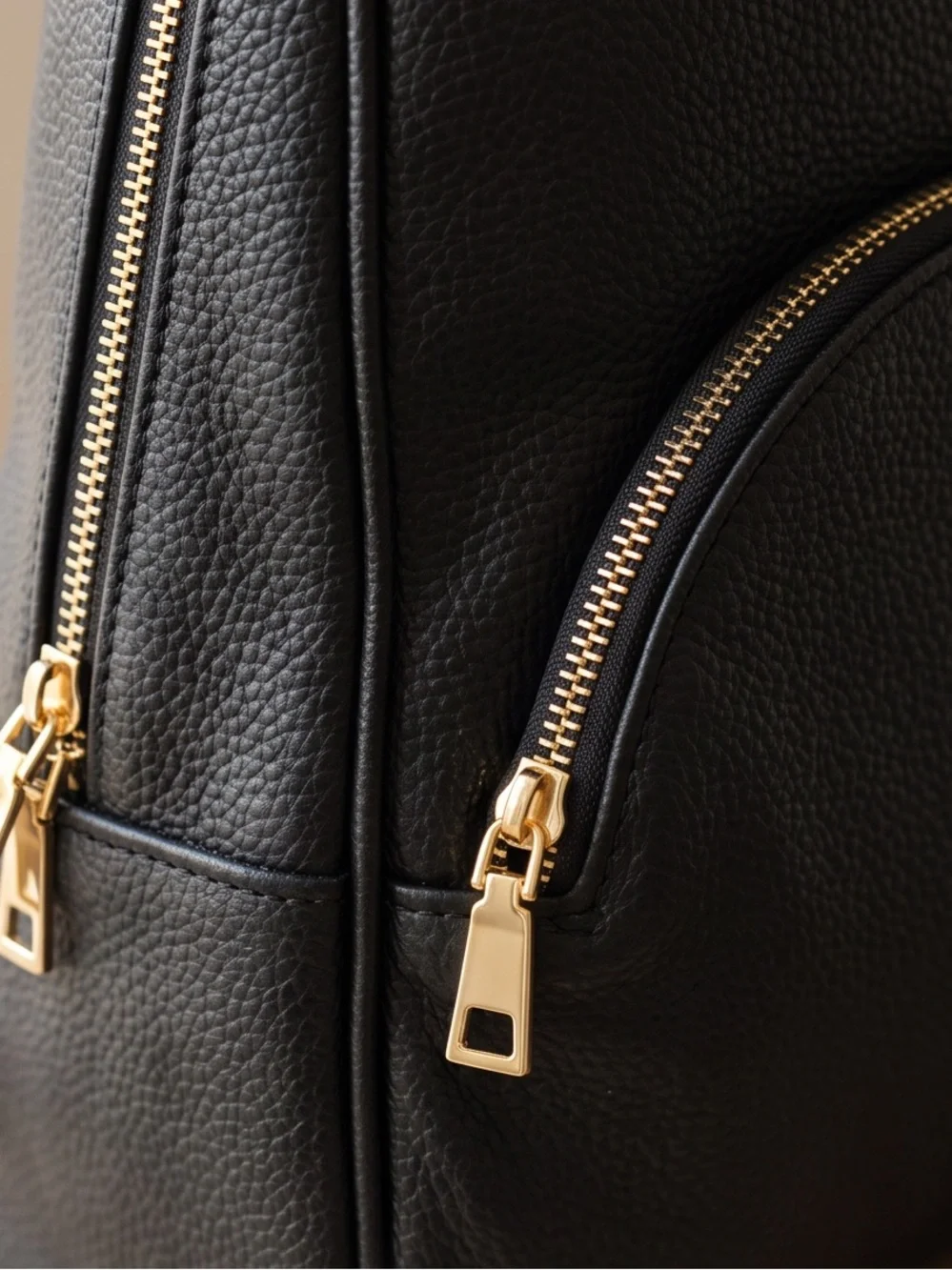 Minimalist Black Pebbled Leather Backpack with Gold Hardware