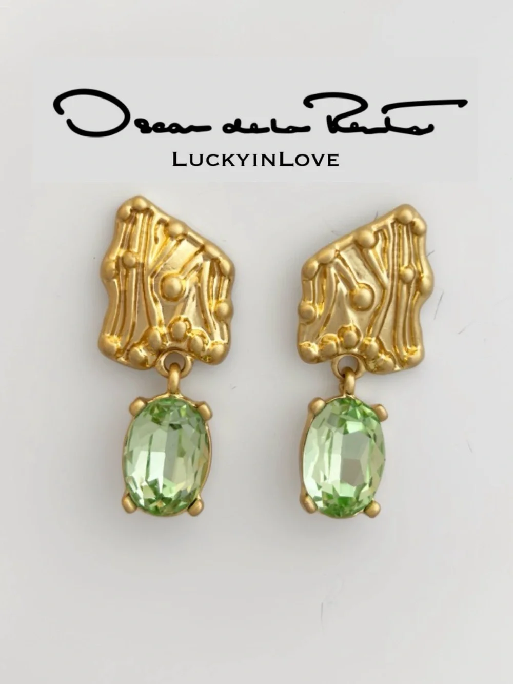 OSCAR DE LA RENTA • Enoki Shield Crystal Drop Earrings in Peridot Green.