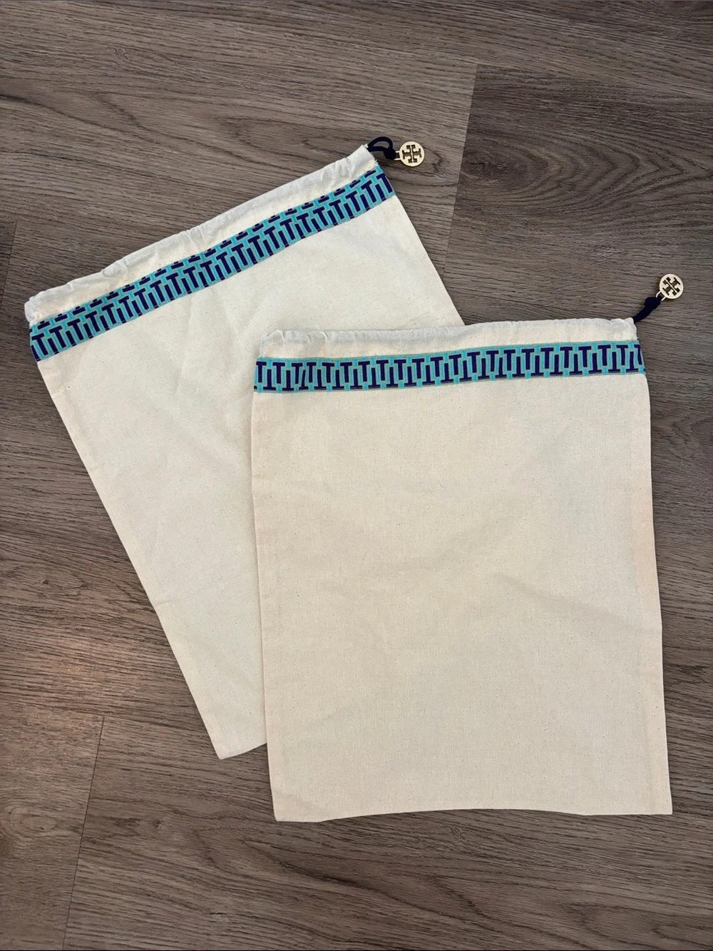 Set of 2 Tory Burch drawstring dust bags, canvas with gold charm