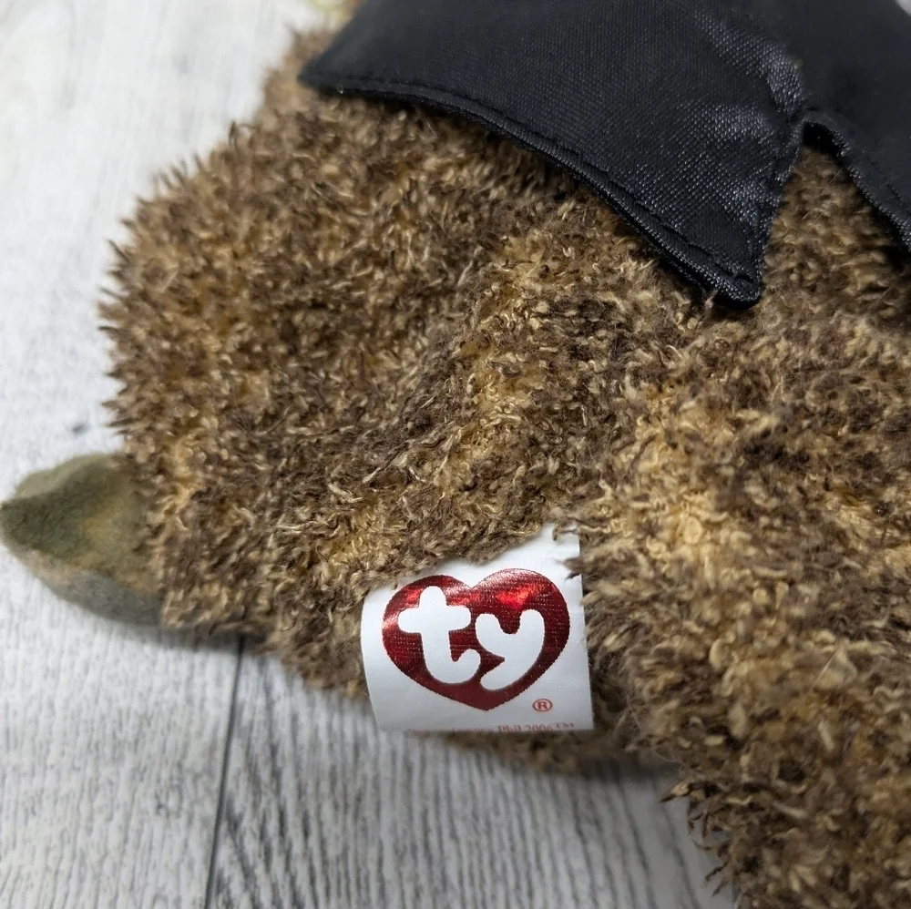 Ty Brown Stuffed Bear with Black Hat and Purple Bow