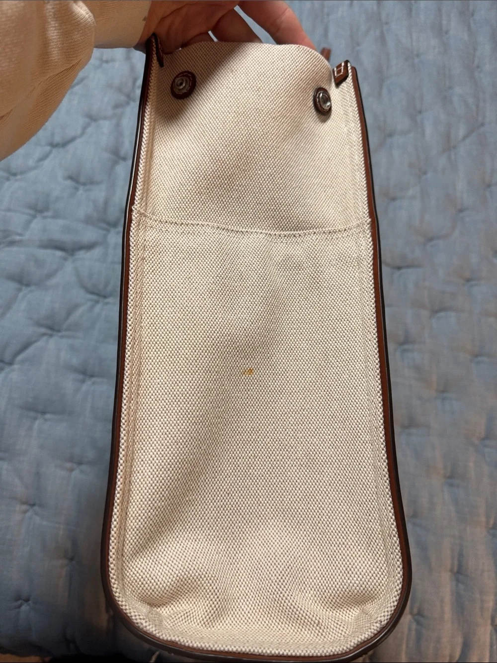 Tory Burch holds 15”