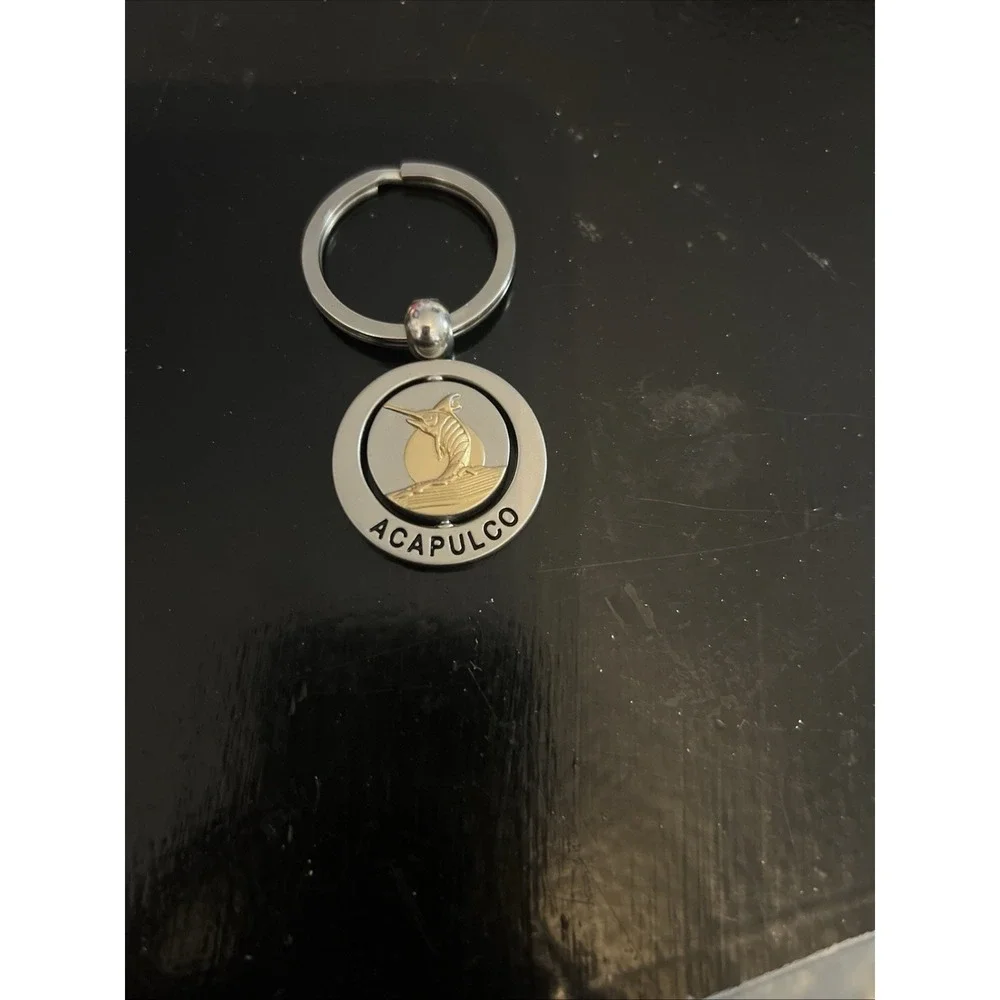 round metal Acapulco‎ souvenir keychain featuring a sailfish design